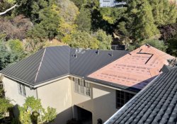 Northbay Roofing team installing a sleek metal roof on a Sebastopol home, showcasing quality craftsmanship and durability.